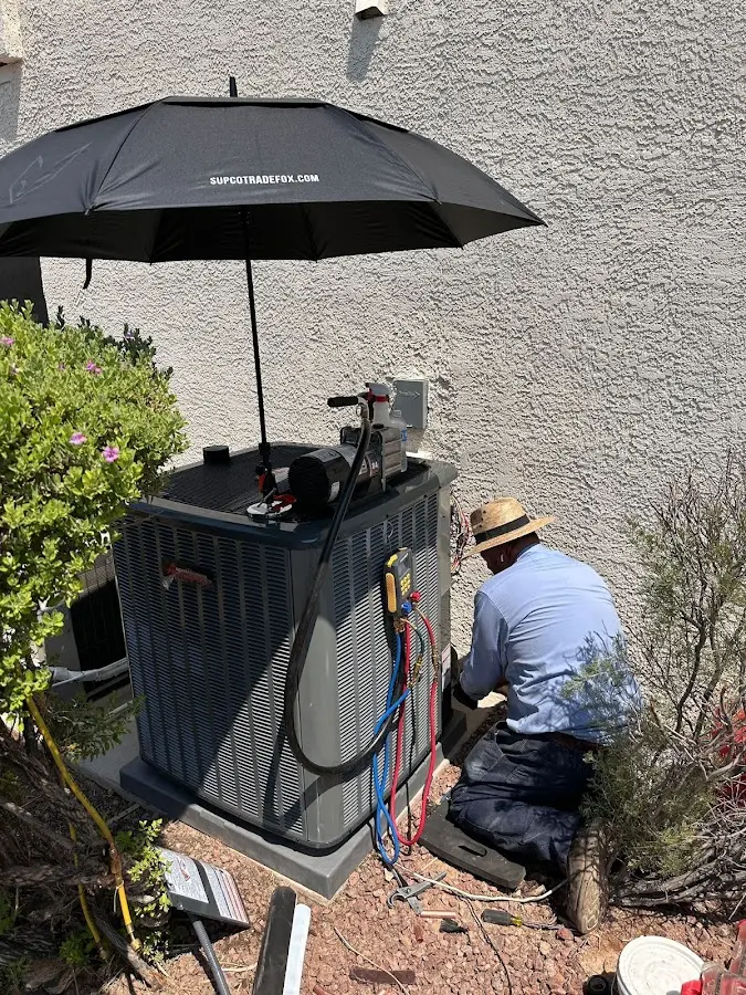 HVAC technician performing outdoor AC maintenance in Parsippany-Troy Hills