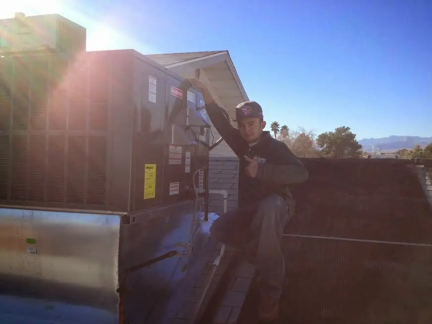 HVAC technician performing AC Tune-Up on a rooftop unit in Parsippany-Troy Hills